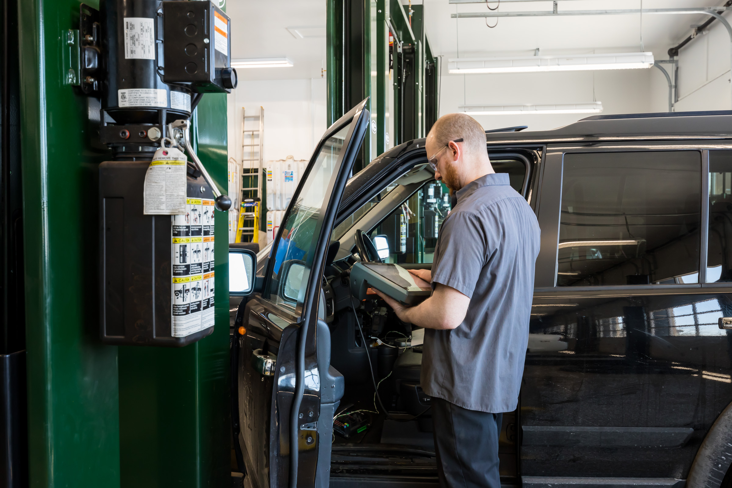 CBAC technician working on vehicle on garage bay
